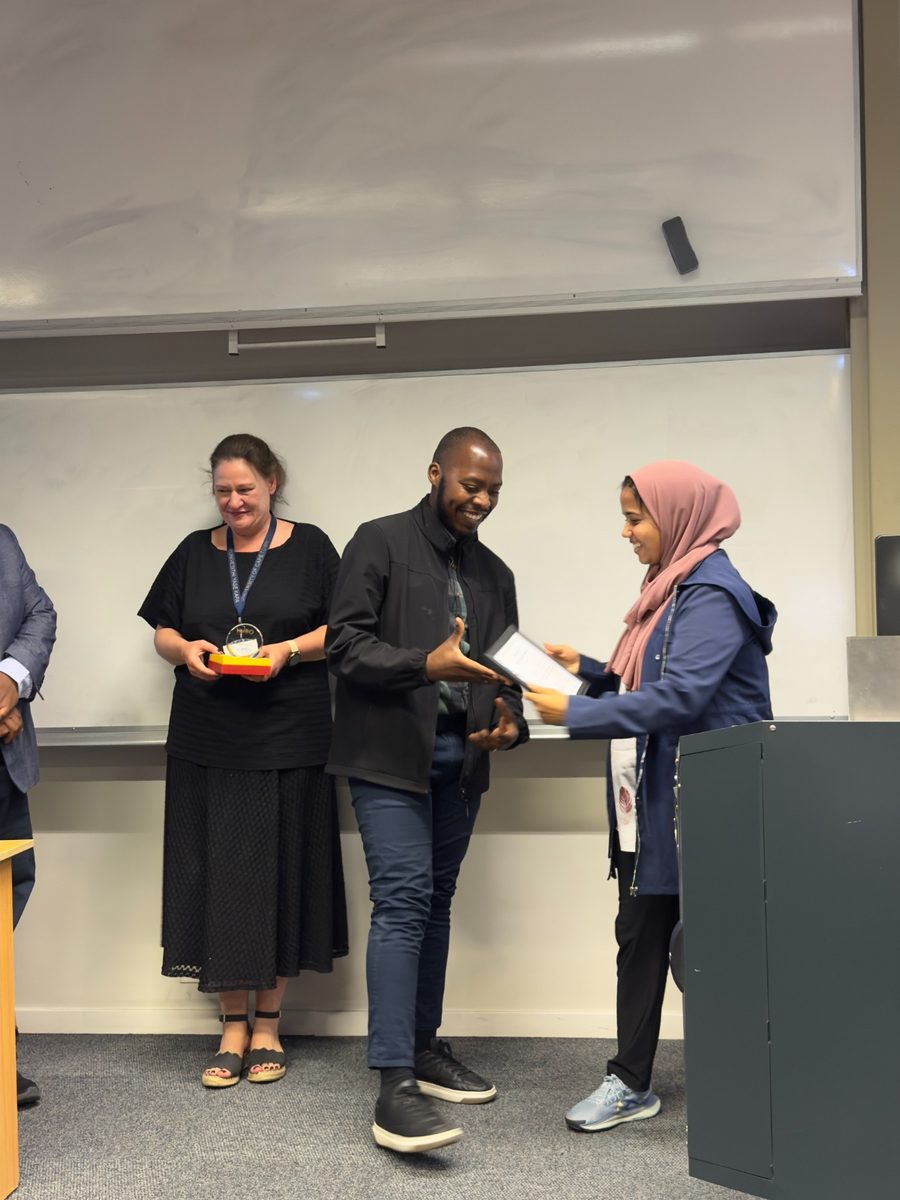 Prosper being handed the award certificate