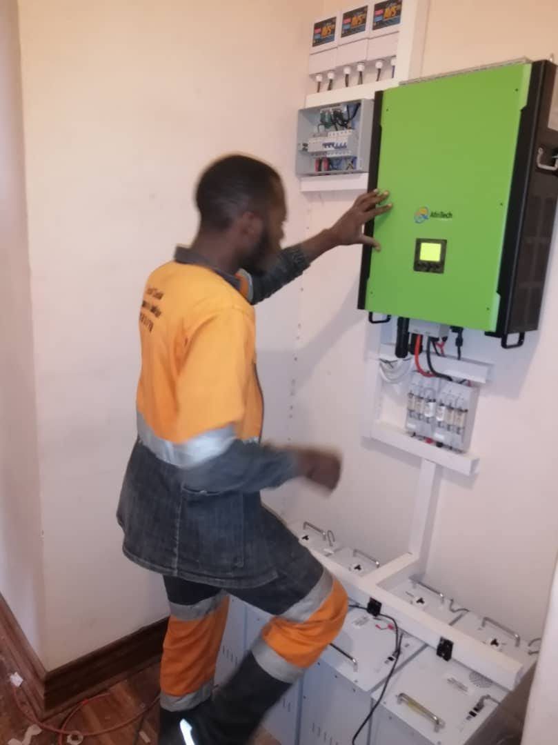 Prosper wiring a solar inverter on a wall